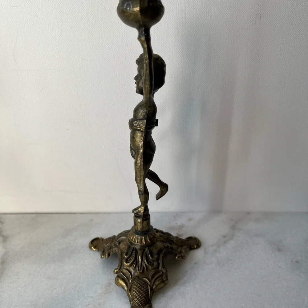 Antique cherub figurine candle holder